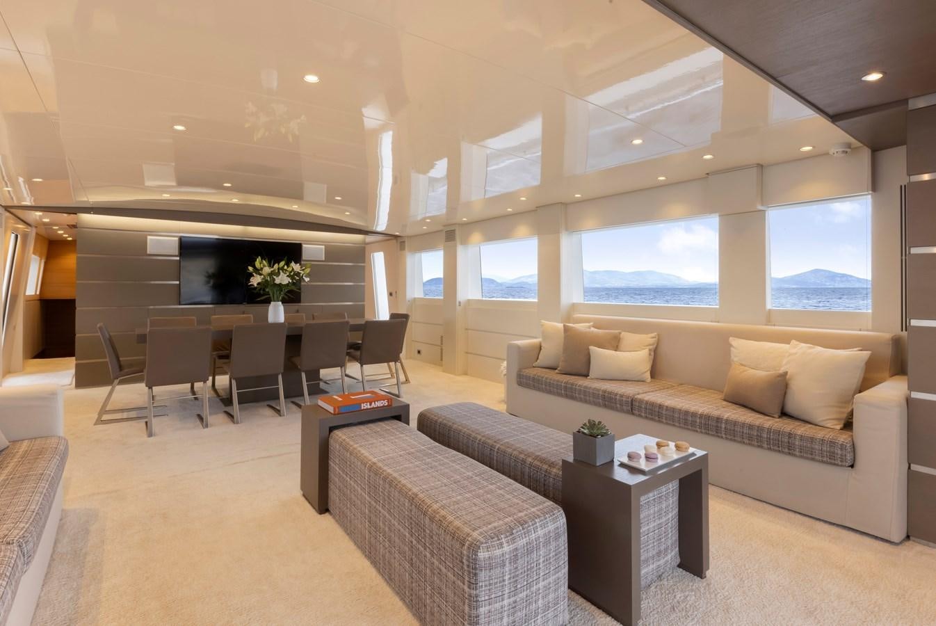 a living room with a couch and a table aboard TROPICANA Yacht for Sale