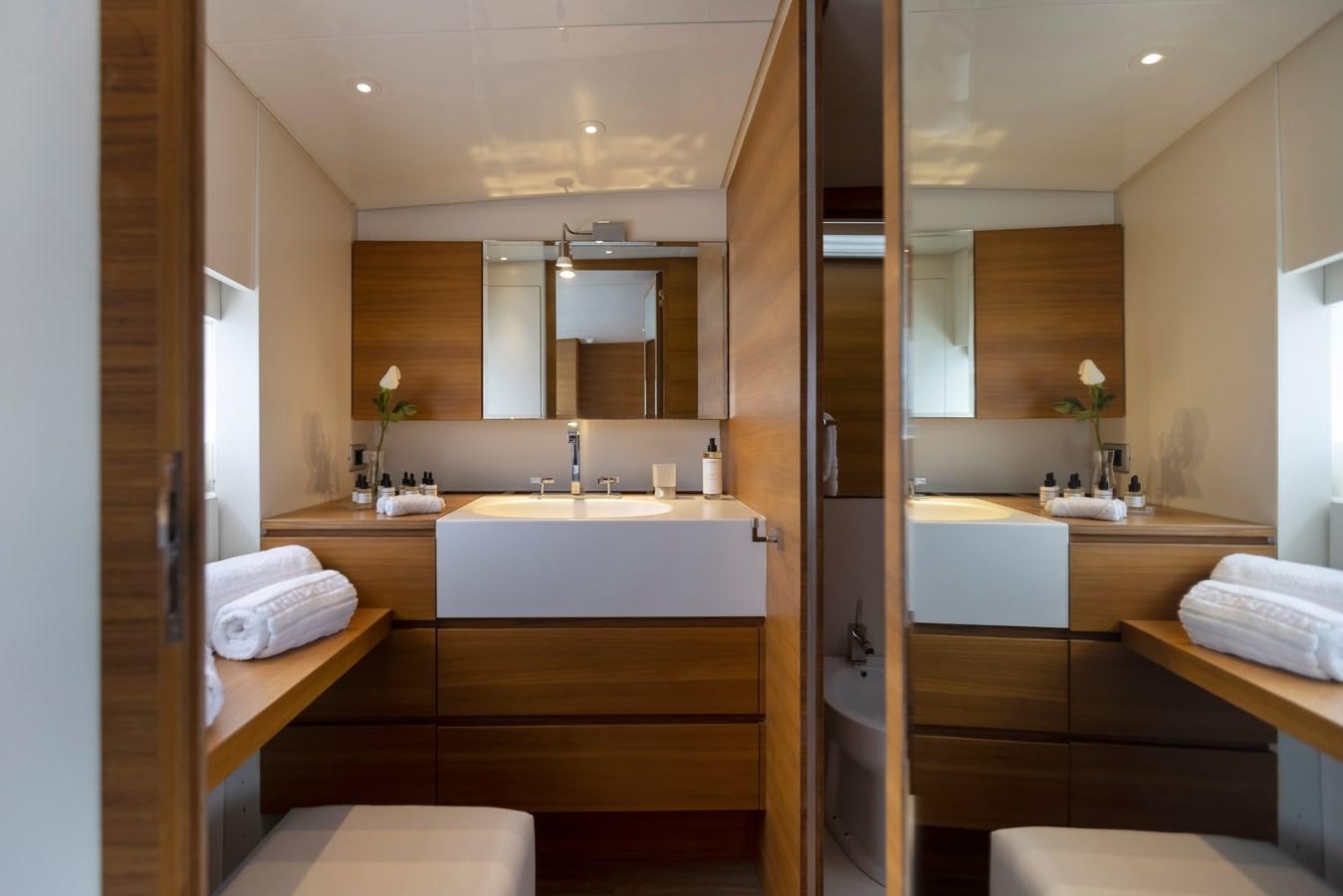 a bathroom with a sink and a mirror aboard TROPICANA Yacht for Sale