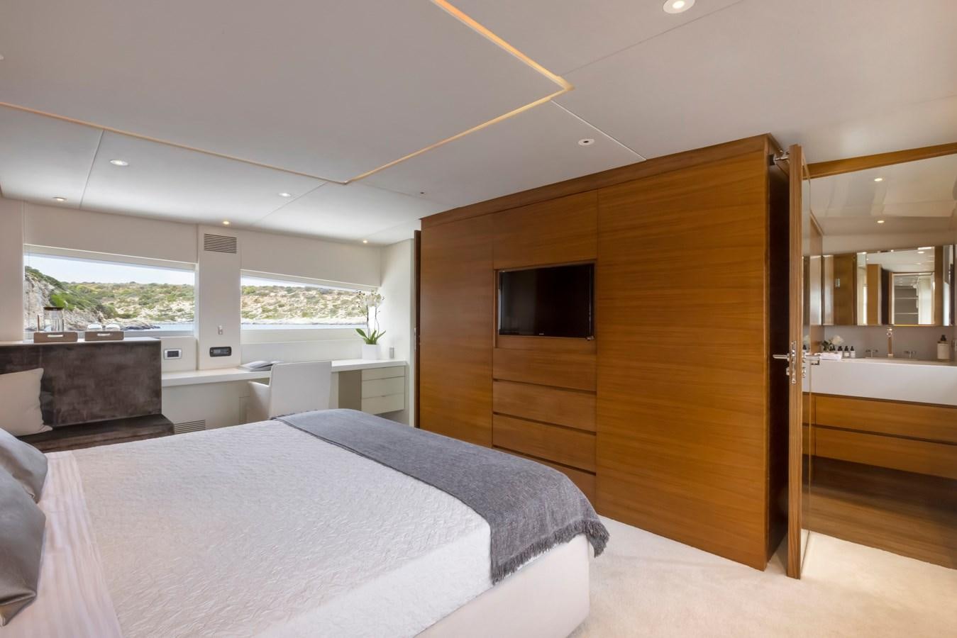 a bedroom with a bed and a tv aboard TROPICANA Yacht for Sale