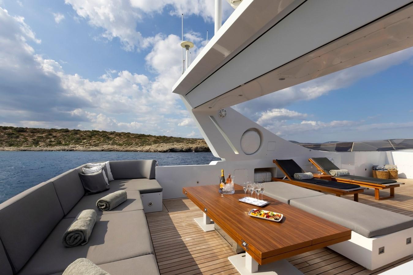 a room with a bed and a table and a large window aboard TROPICANA Yacht for Sale