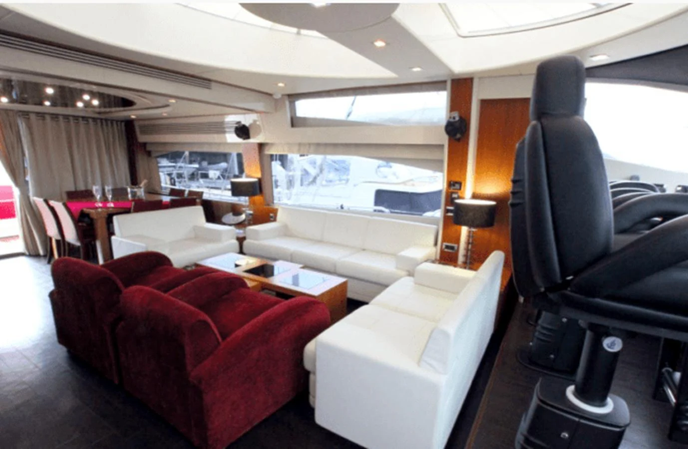 a room with a couch and a table and chairs aboard NOVA 92 Yacht for Sale