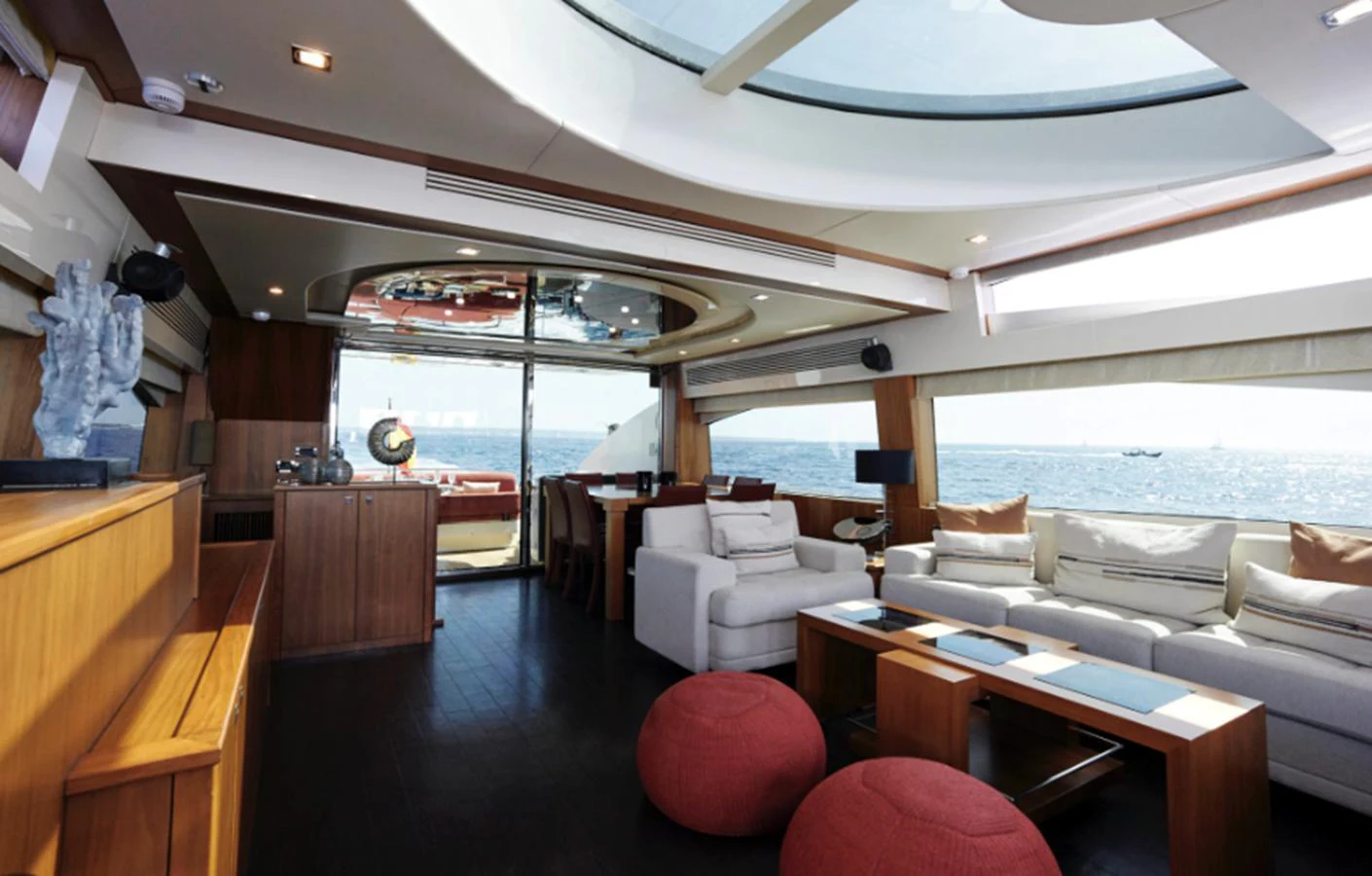 a room with a couch and a table and a large window aboard NOVA 92 Yacht for Sale