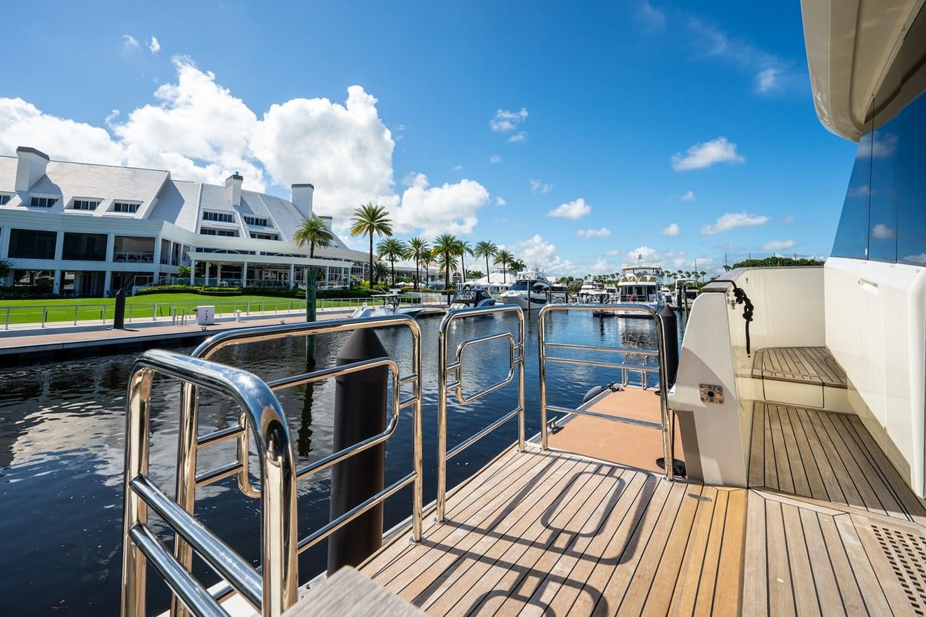 a deck with a view of a beach and a building aboard NEVER SAY NEVER 2015/2023 Yacht for Sale