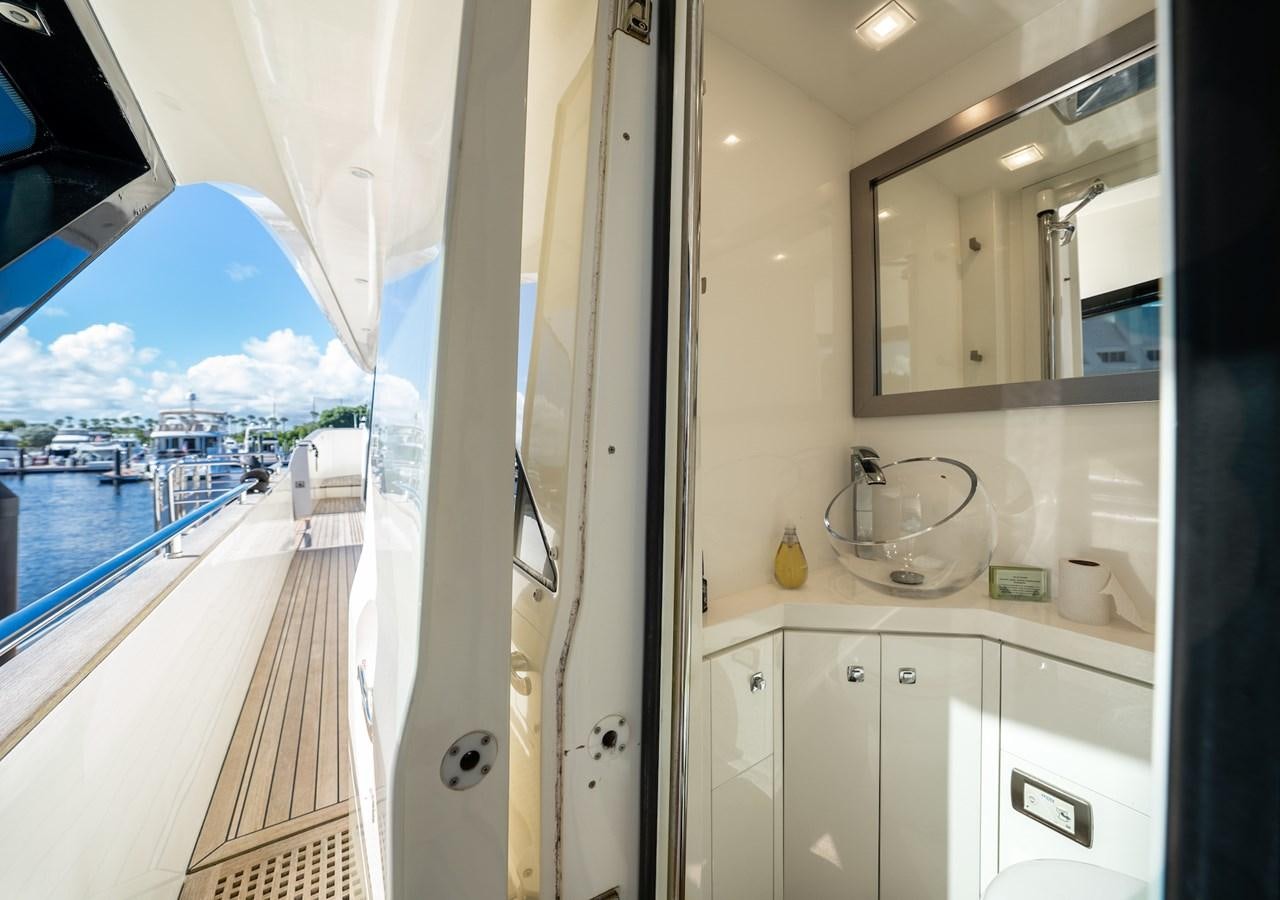 a room with a large mirror and a view of the water aboard NEVER SAY NEVER 2015/2023 Yacht for Sale