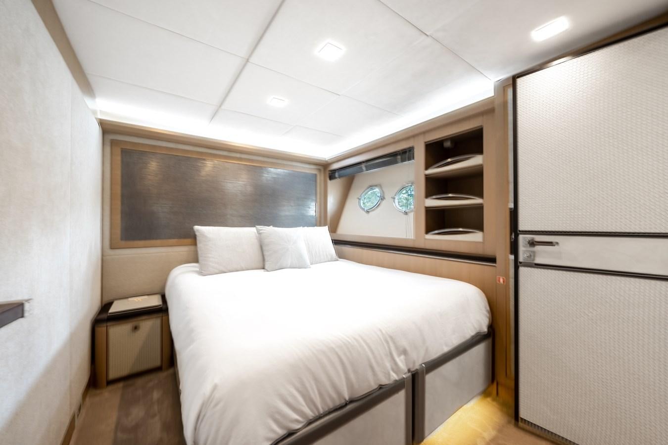a room with a bed and a closet aboard NEVER SAY NEVER 2015/2023 Yacht for Sale