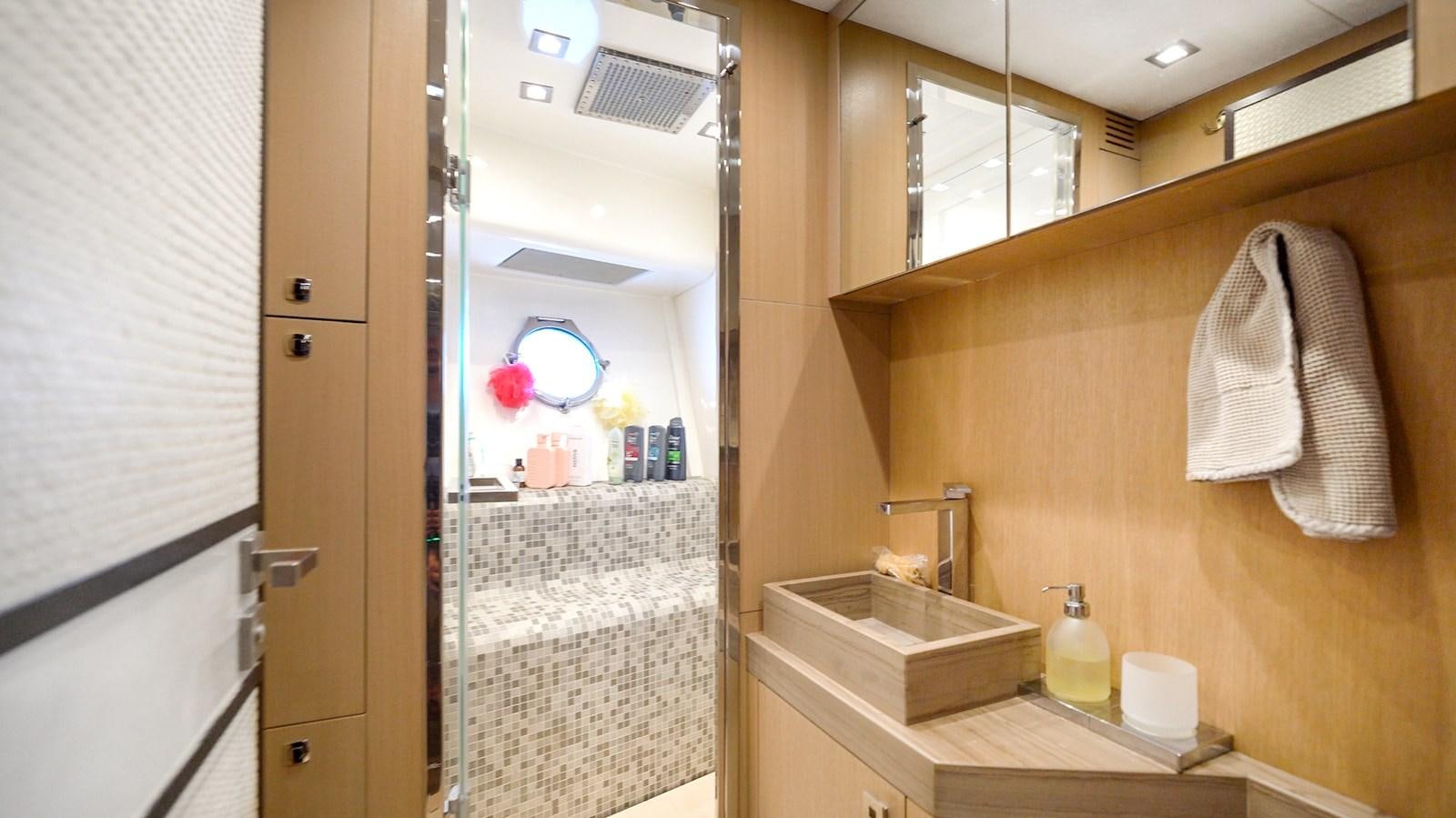 a bathroom with a large mirror aboard NEVER SAY NEVER 2015/2023 Yacht for Sale