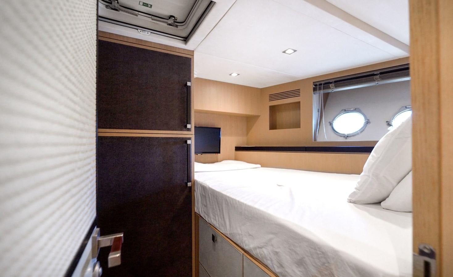 a room with a bed and a television aboard NEVER SAY NEVER 2015/2023 Yacht for Sale