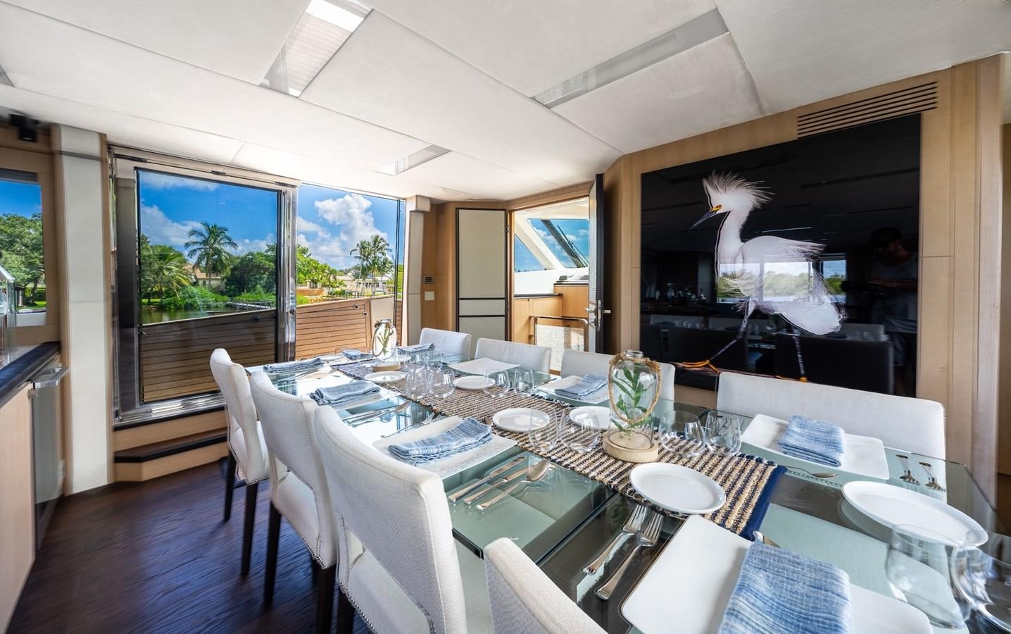 a dining room with a table and chairs aboard NEVER SAY NEVER 2015/2023 Yacht for Sale