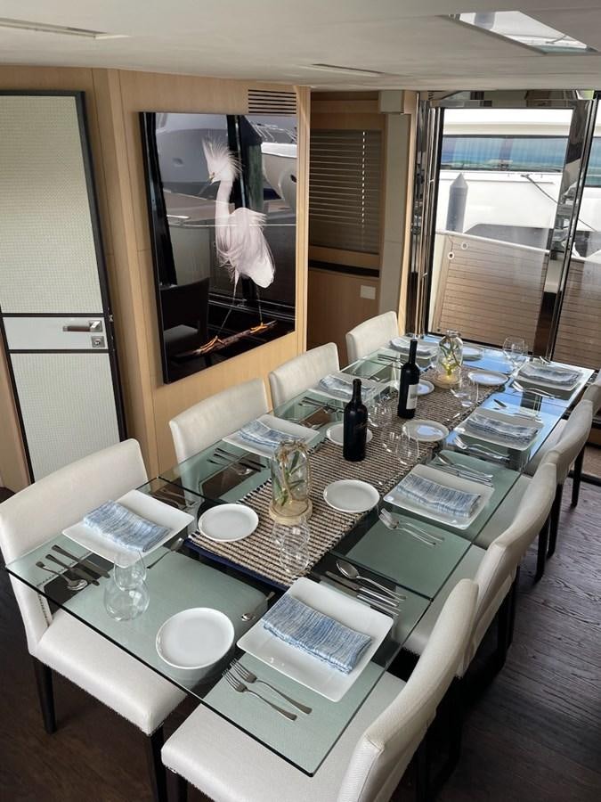 a table with plates and glasses on it aboard NEVER SAY NEVER 2015/2023 Yacht for Sale