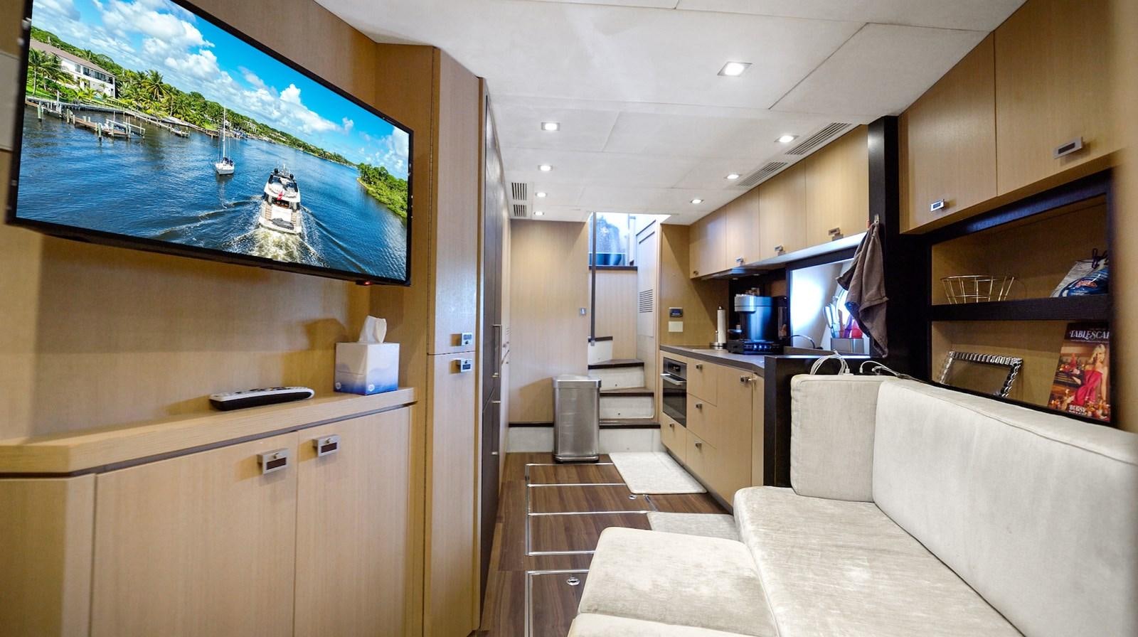 a living room with a couch and a tv aboard NEVER SAY NEVER 2015/2023 Yacht for Sale