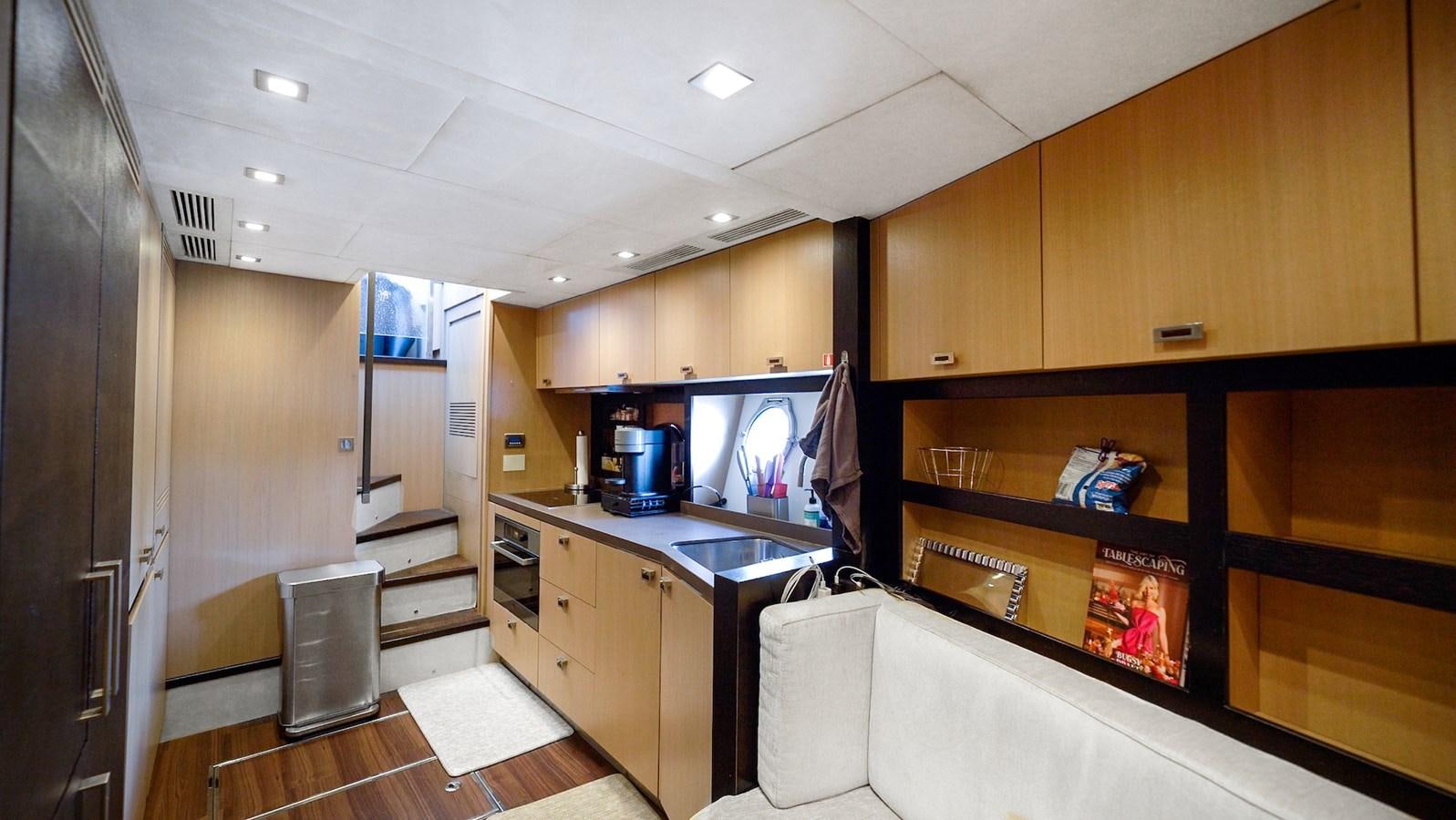 a kitchen with wooden cabinets aboard NEVER SAY NEVER 2015/2023 Yacht for Sale