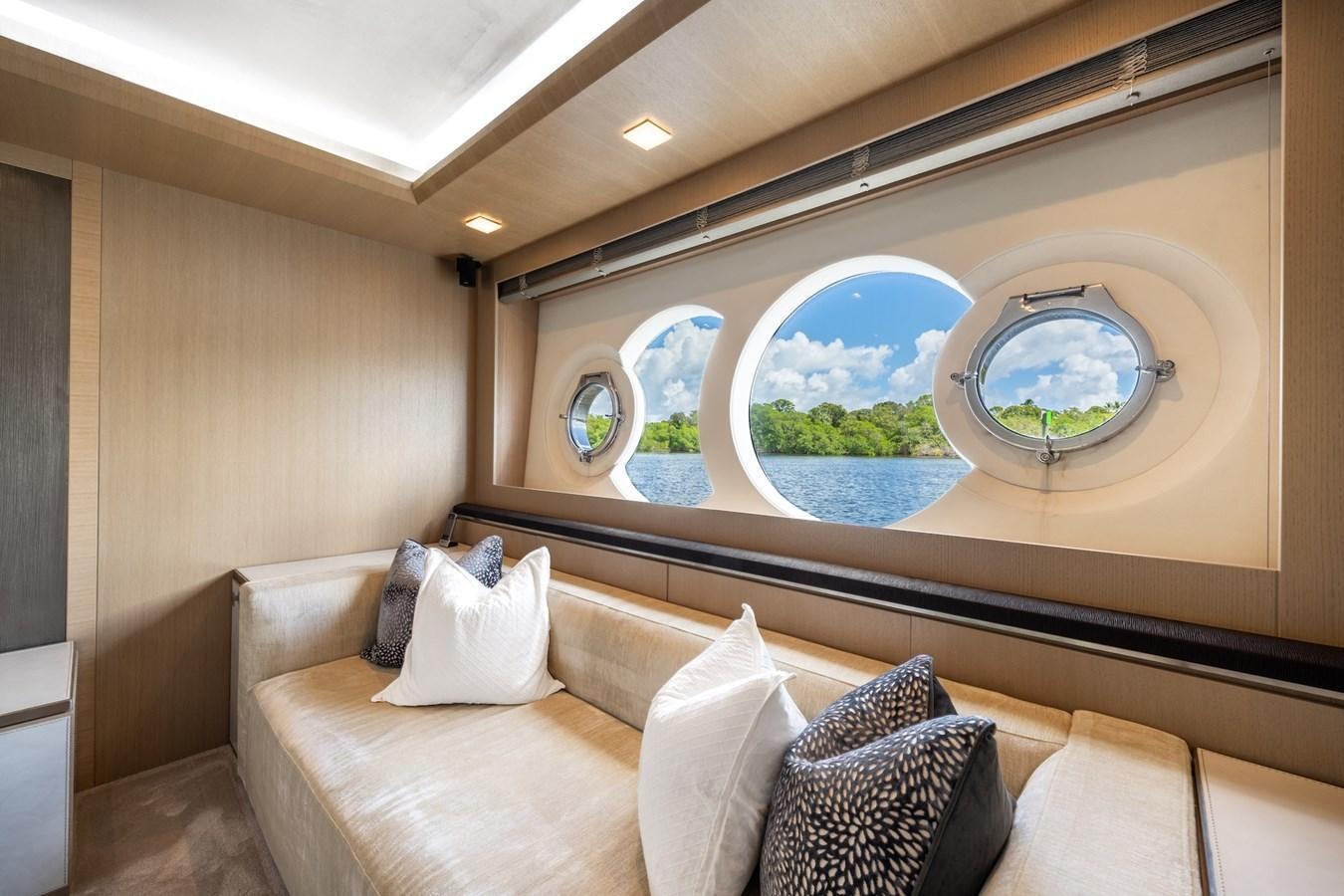 a room with a couch and a large fish tank aboard NEVER SAY NEVER 2015/2023 Yacht for Sale