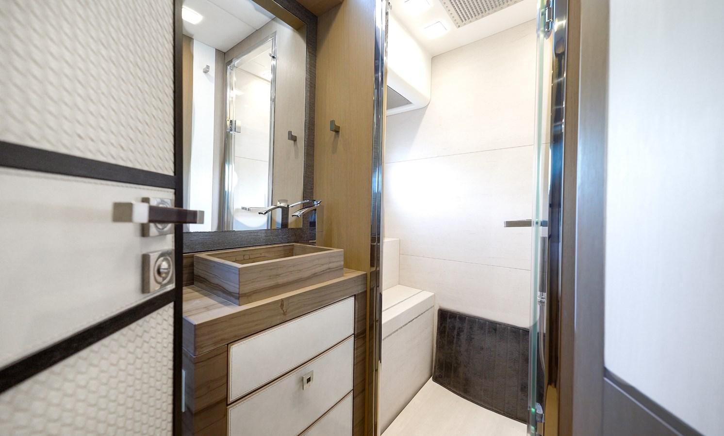 a bathroom with a sink and a mirror aboard NEVER SAY NEVER 2015/2023 Yacht for Sale