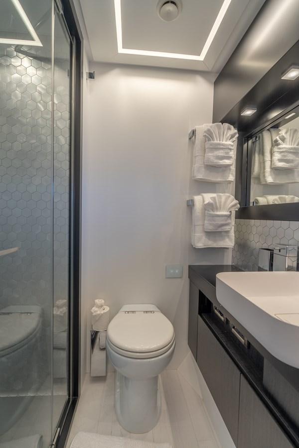 a bathroom with a glass shower aboard VINTAGE Yacht for Sale