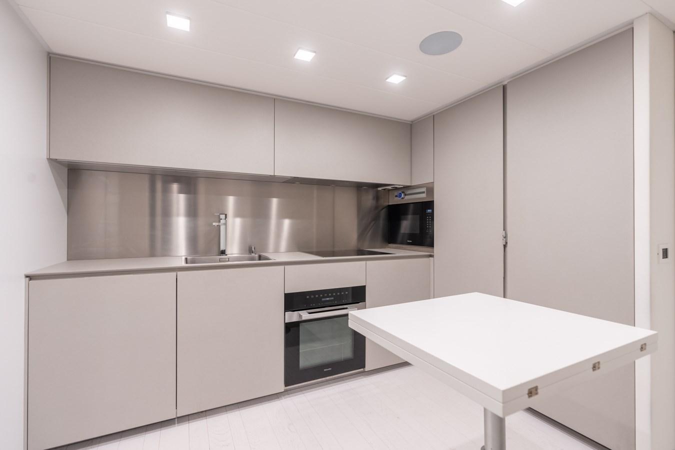 a kitchen with white cabinets aboard VINTAGE Yacht for Sale