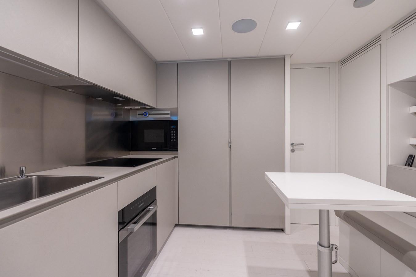 a kitchen with white cabinets aboard VINTAGE Yacht for Sale