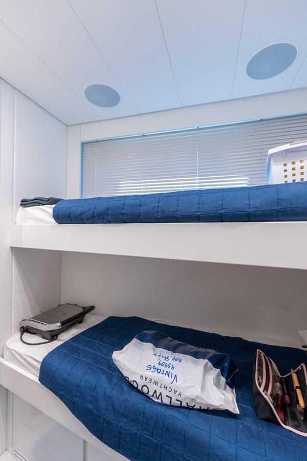 a bed with a blue blanket aboard VINTAGE Yacht for Sale