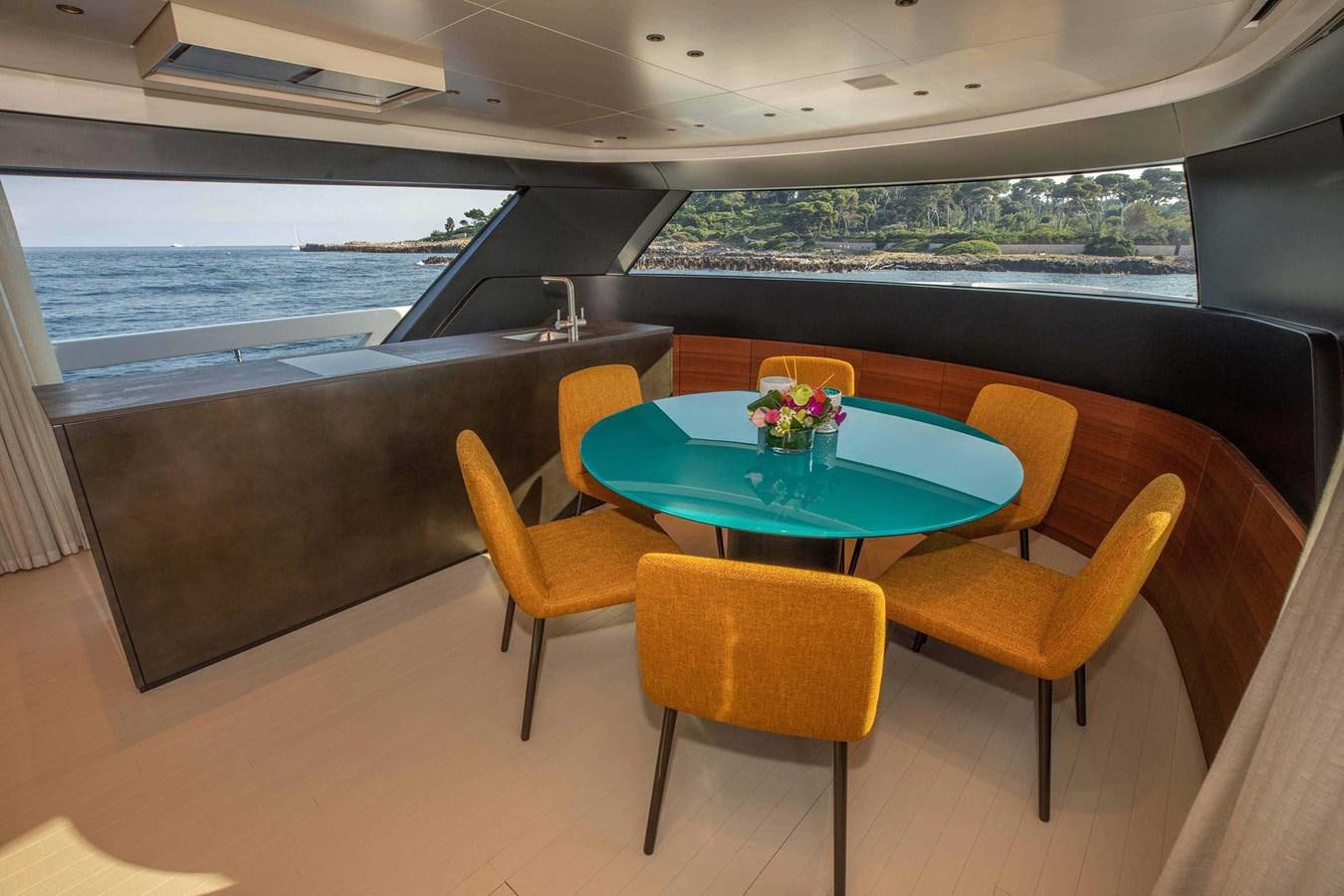 a table and chairs on a balcony aboard 2019 SANLORENZO SX76 #16 Yacht for Sale