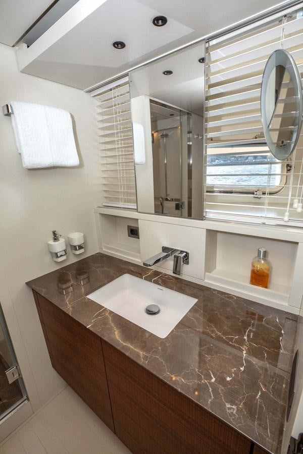 a bathroom with a countertop sink and mirrors aboard 2019 SANLORENZO SX76 #16 Yacht for Sale