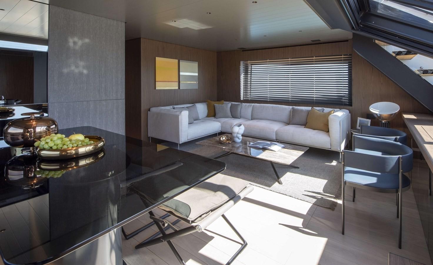 a modern living room with a glass table and a couch aboard 2024  BLUEGAME BG72/BG74 Yacht for Sale