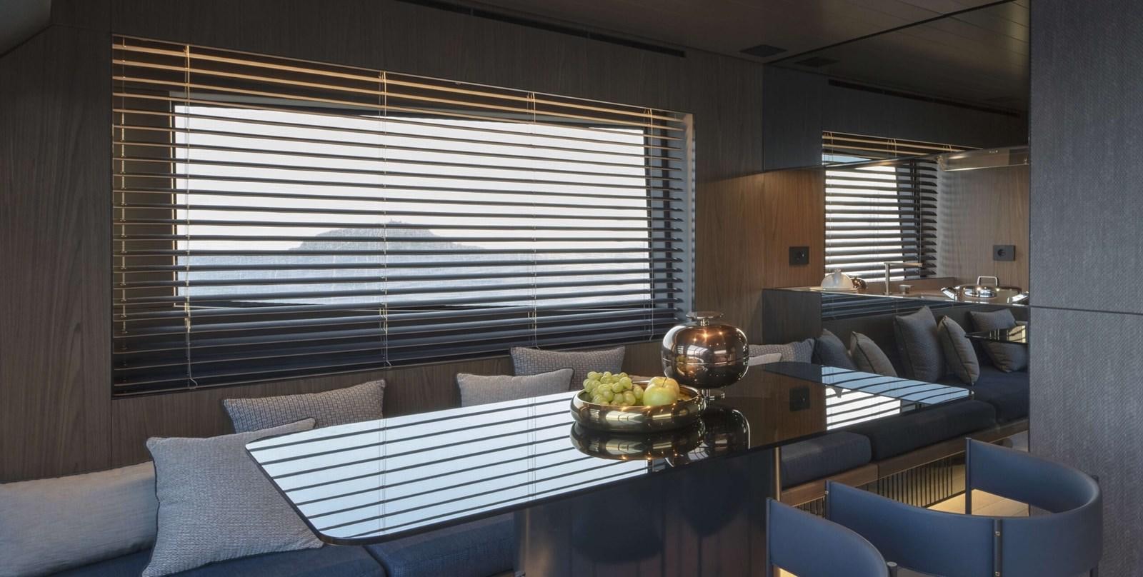 a room with a table and couches aboard 2024  BLUEGAME BG72/BG74 Yacht for Sale