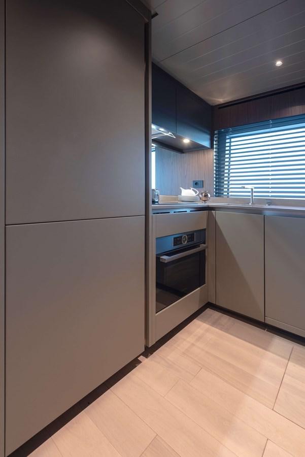a kitchen with a large window aboard 2024  BLUEGAME BG72/BG74 Yacht for Sale