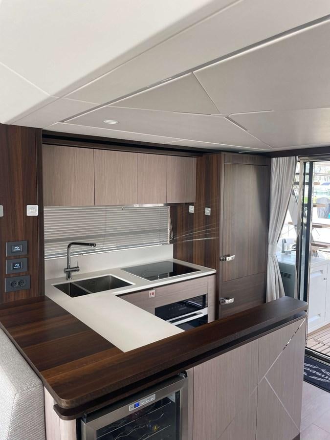 a kitchen with wooden cabinets aboard SUNSEEKER 70' MANHATTAN Yacht for Sale