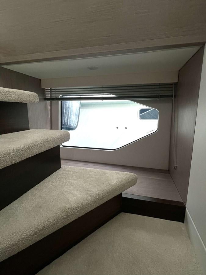 a bed and a window in a room aboard SUNSEEKER 70' MANHATTAN Yacht for Sale