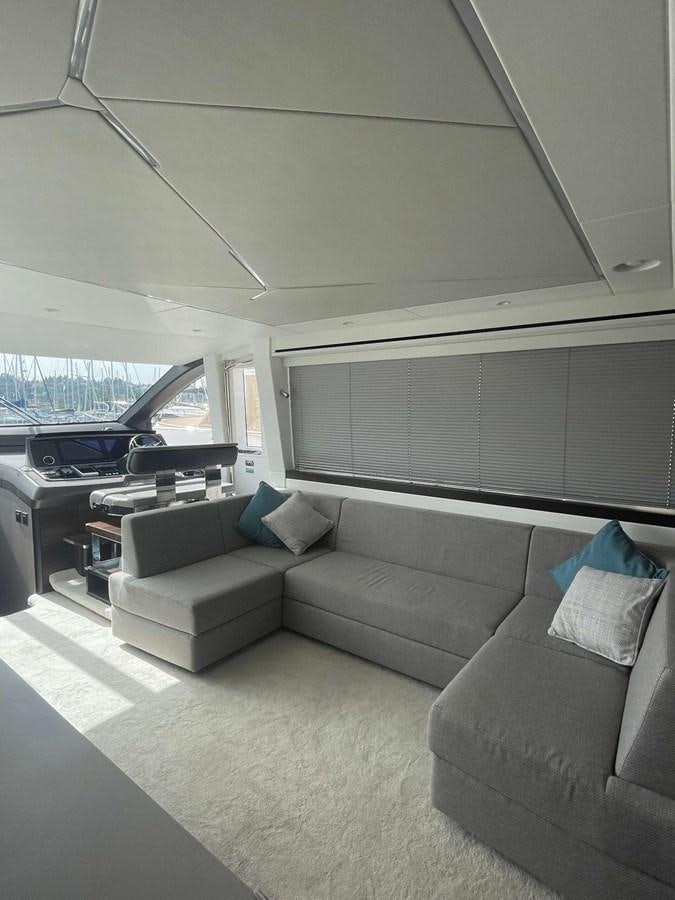 a living room with a couch and a window aboard SUNSEEKER 70' MANHATTAN Yacht for Sale