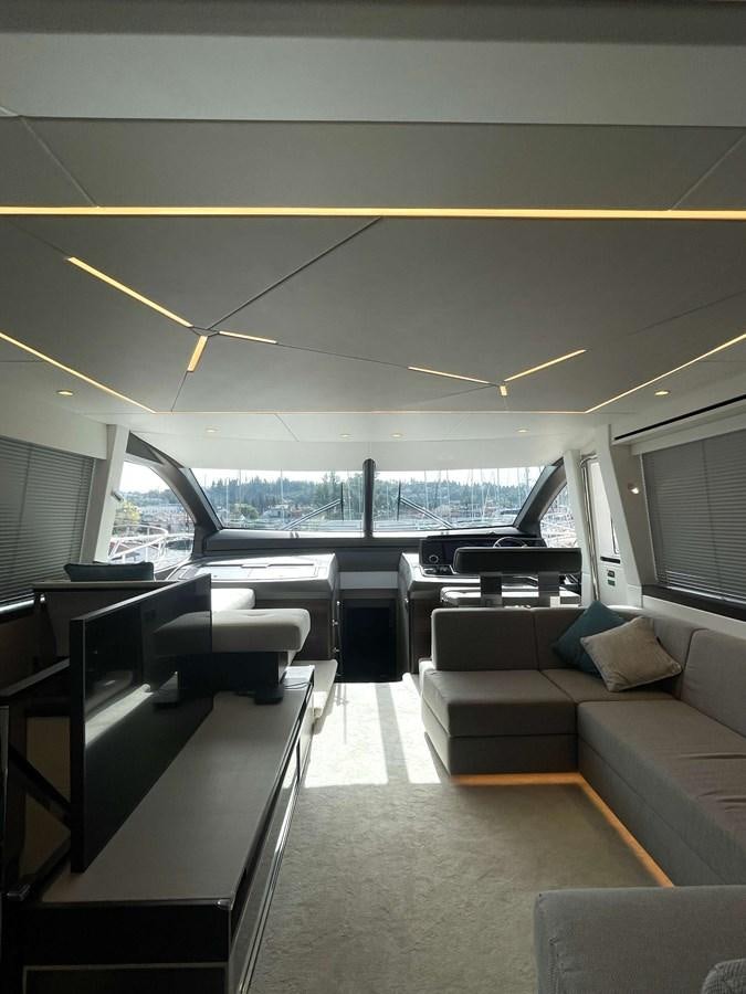 a room with couches and a table aboard SUNSEEKER 70' MANHATTAN Yacht for Sale