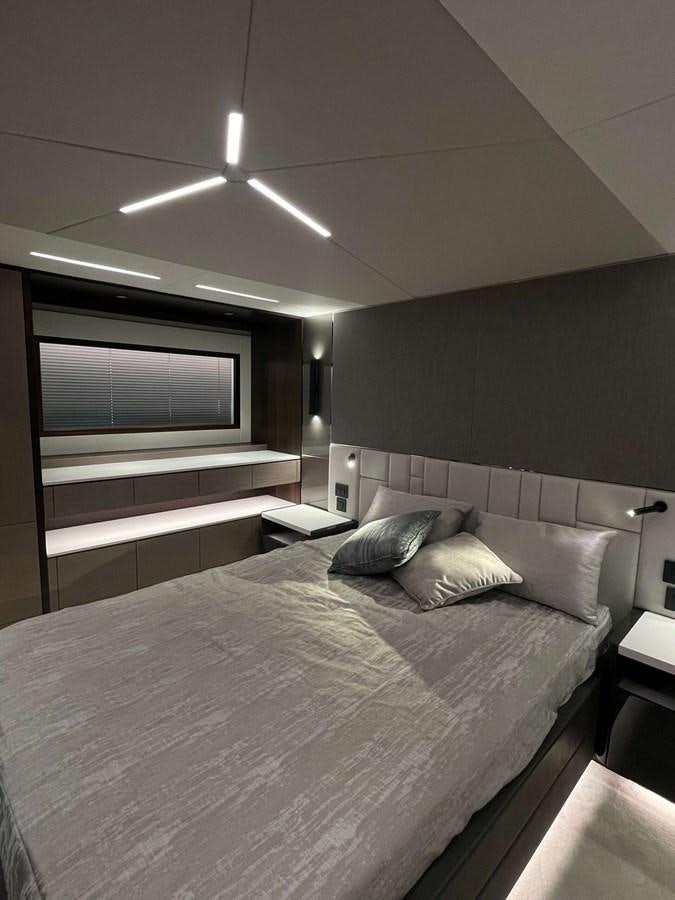 a room with a bed and a television aboard SUNSEEKER 70' MANHATTAN Yacht for Sale