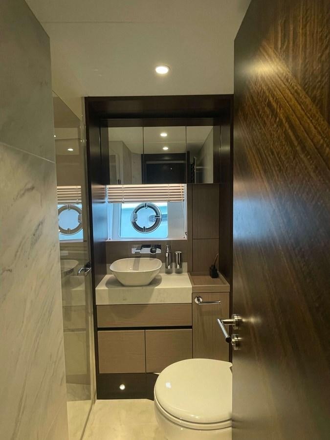 a bathroom with a large mirror aboard SUNSEEKER 70' MANHATTAN Yacht for Sale