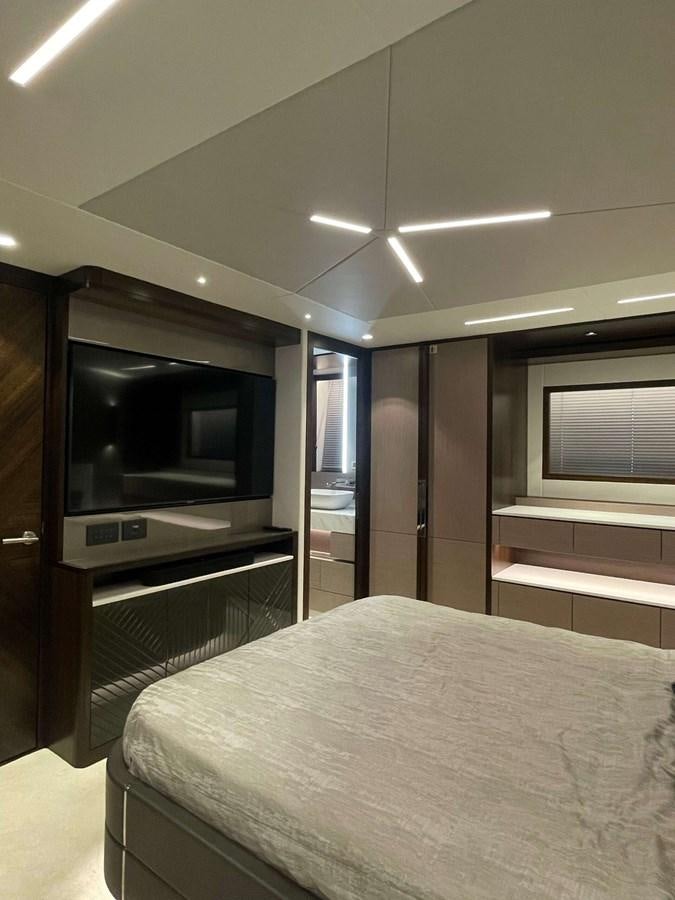 a bedroom with a bed and tv aboard SUNSEEKER 70' MANHATTAN Yacht for Sale