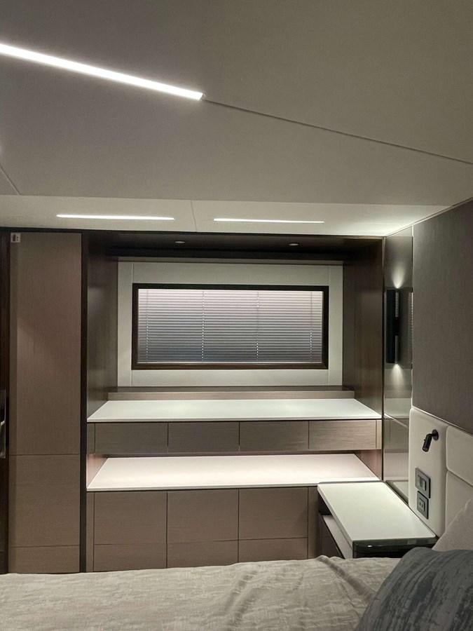 a room with a bed and a window aboard SUNSEEKER 70' MANHATTAN Yacht for Sale