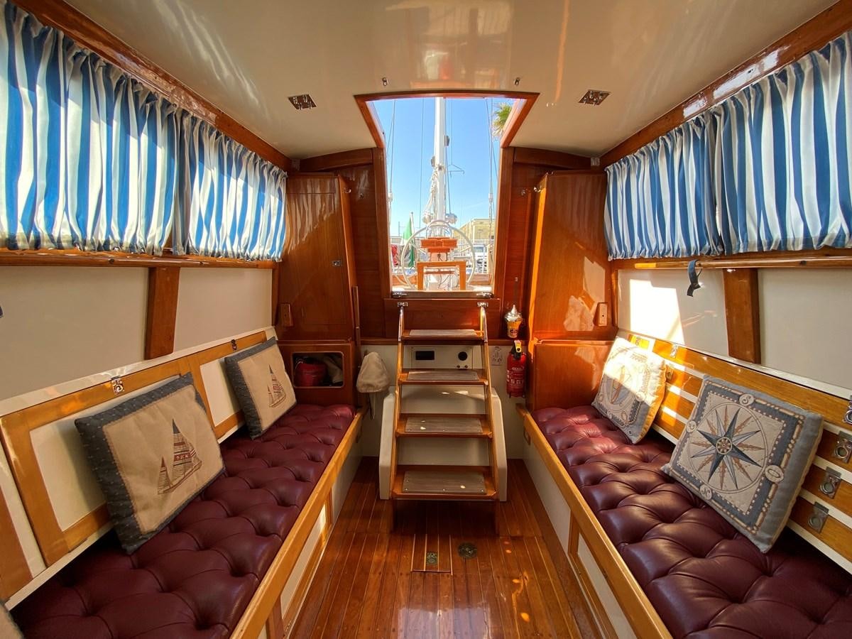 a room with a bed and a mirror aboard WINDIGO Yacht for Sale