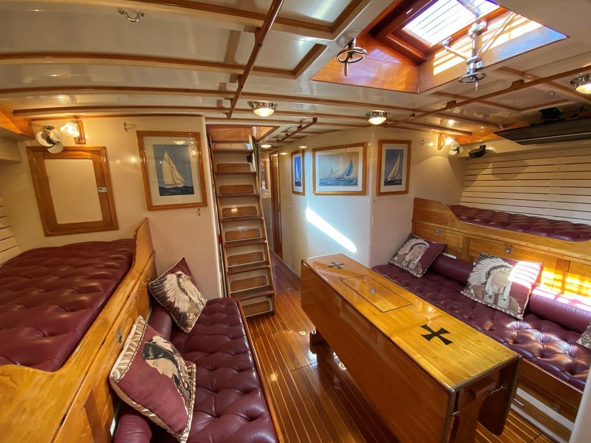 a room with a couch and a table aboard WINDIGO Yacht for Sale