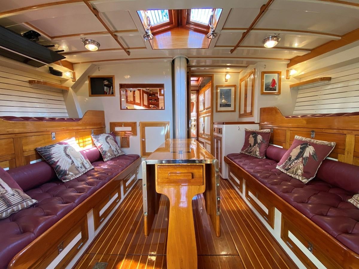 a living room with a wood floor aboard WINDIGO Yacht for Sale