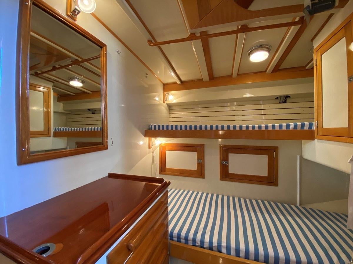 a room with a mirror and a bed aboard WINDIGO Yacht for Sale