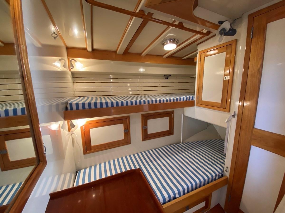 a cabin with a bed aboard WINDIGO Yacht for Sale