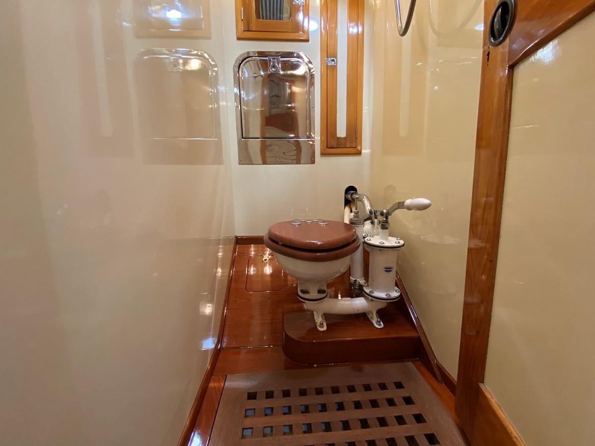 a bathroom with a toilet and sink aboard WINDIGO Yacht for Sale