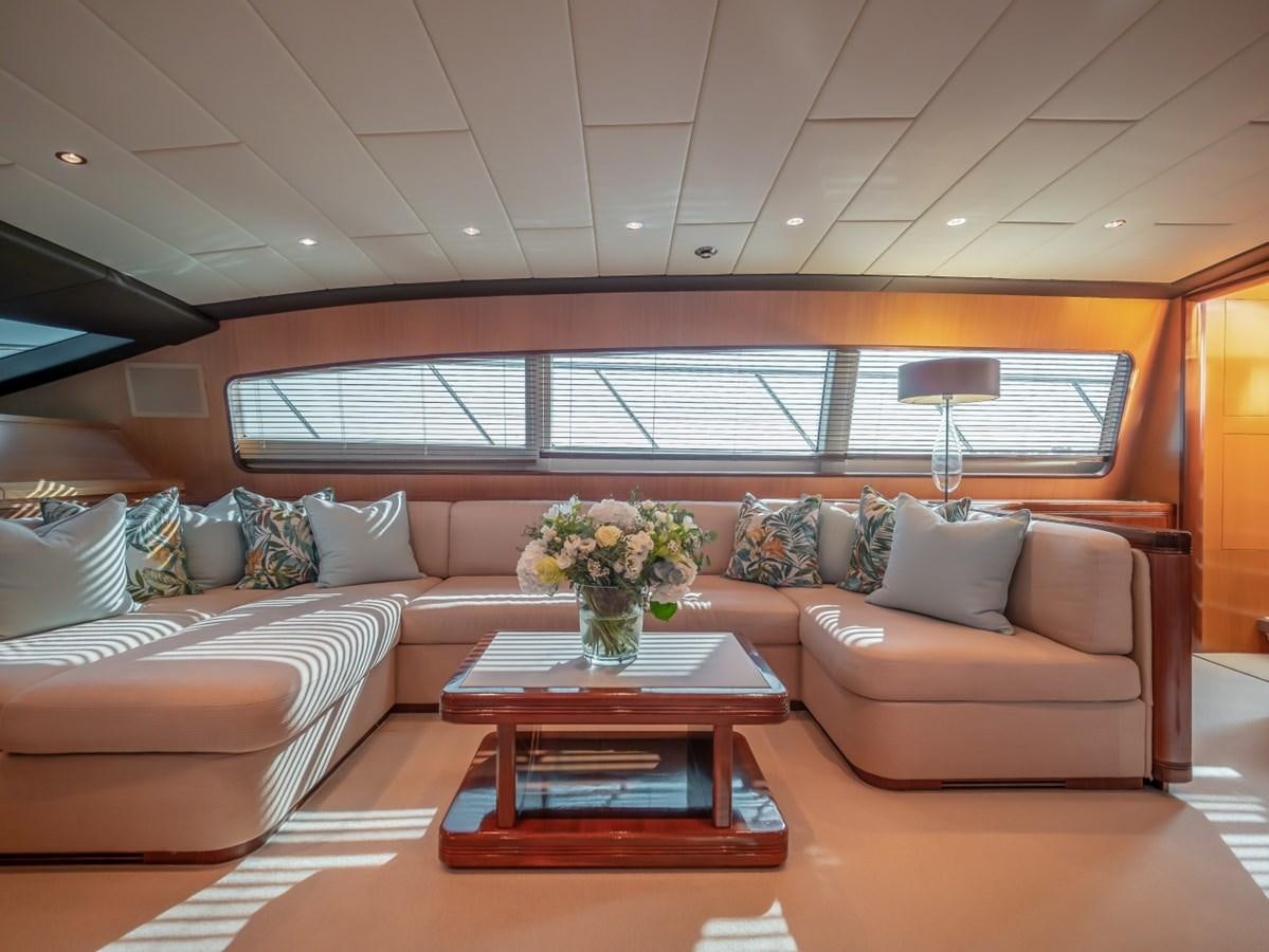 a living room with a couch and a coffee table aboard WET PANTHER Yacht for Sale