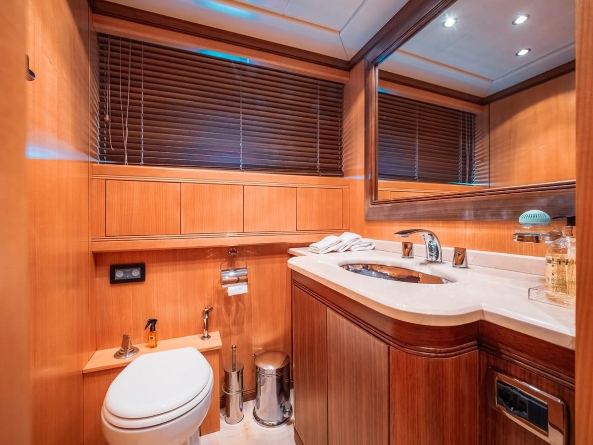 a bathroom with wooden cabinets aboard WET PANTHER Yacht for Sale