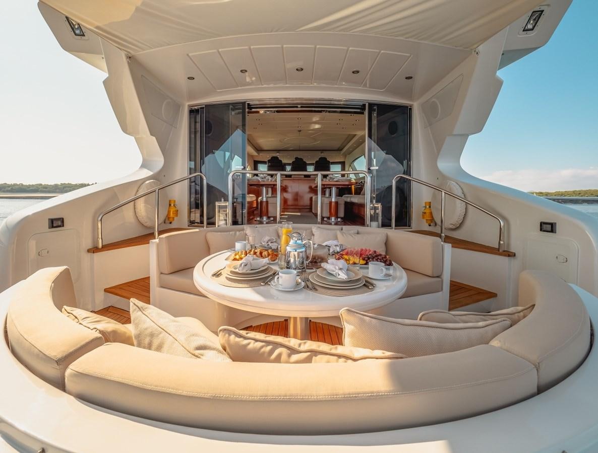 a large white space ship with a table and plates and chairs aboard WET PANTHER Yacht for Sale