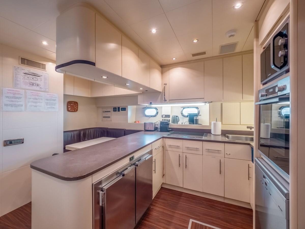 a kitchen with a large island aboard WET PANTHER Yacht for Sale