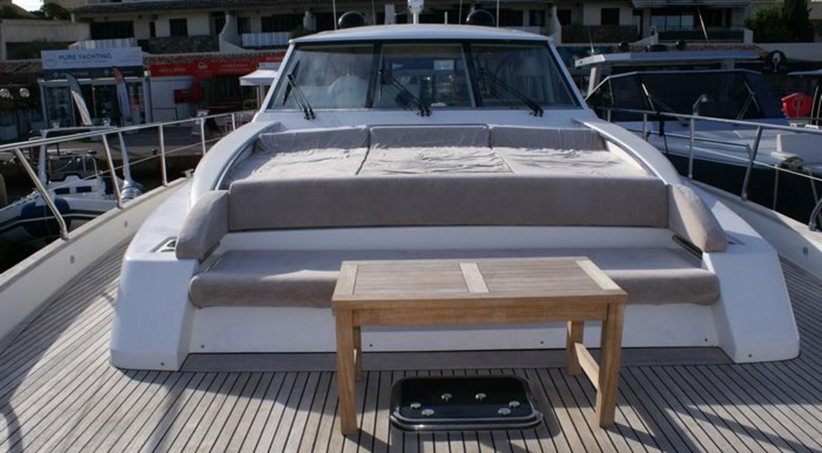a white car with a black tray on a wooden table aboard WILD Yacht for Sale