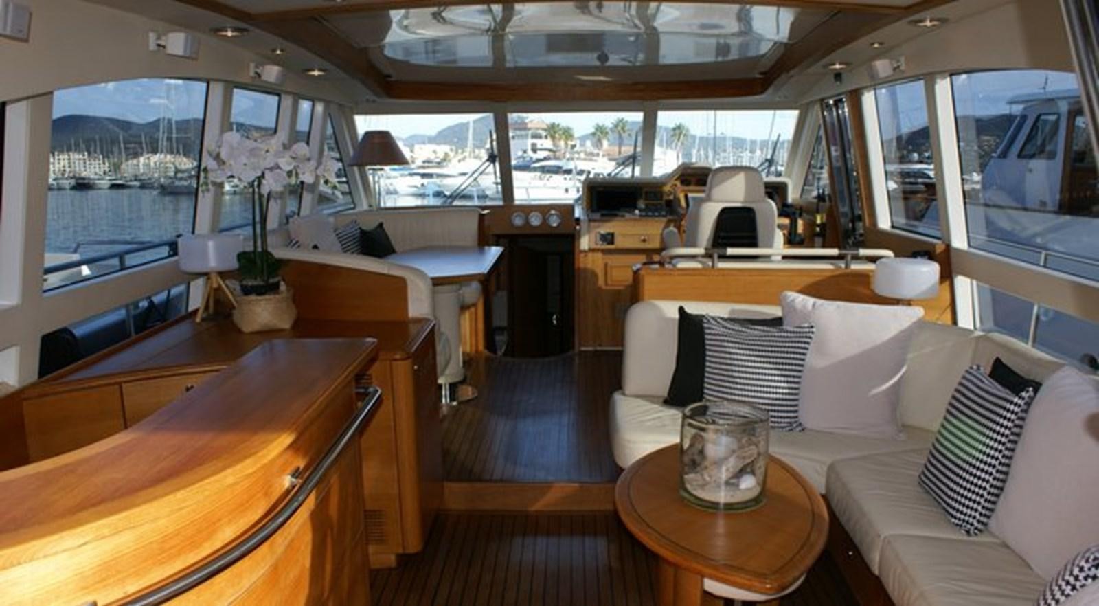 a room with a table and chairs aboard WILD Yacht for Sale