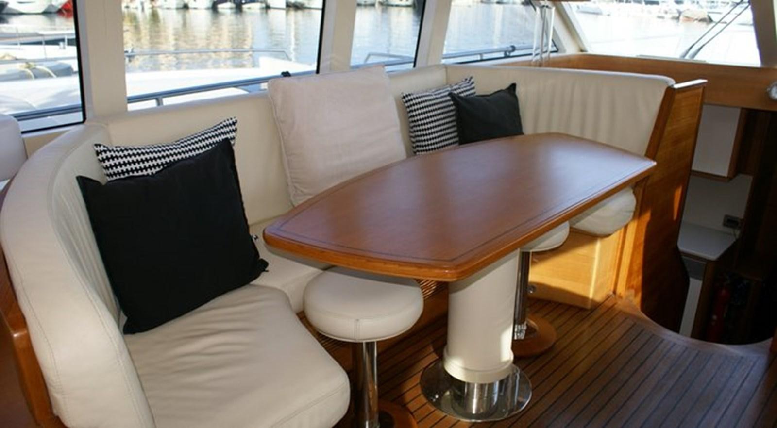 a couch and a table in a room aboard WILD Yacht for Sale