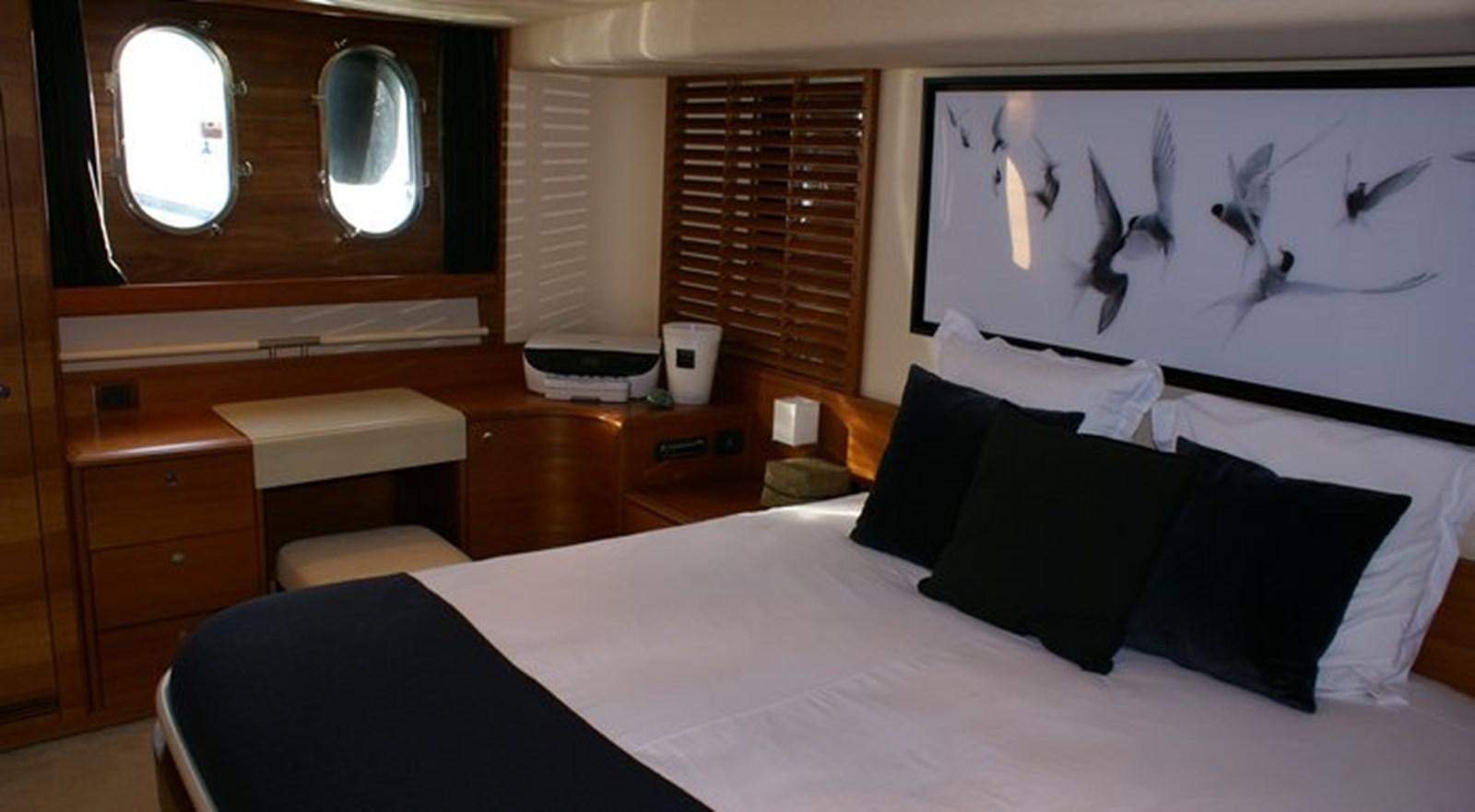 a bedroom with a bed and a desk aboard WILD Yacht for Sale