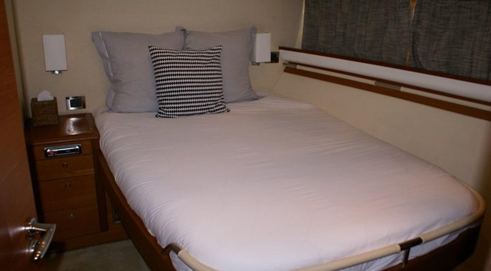 a bed with white sheets aboard WILD Yacht for Sale