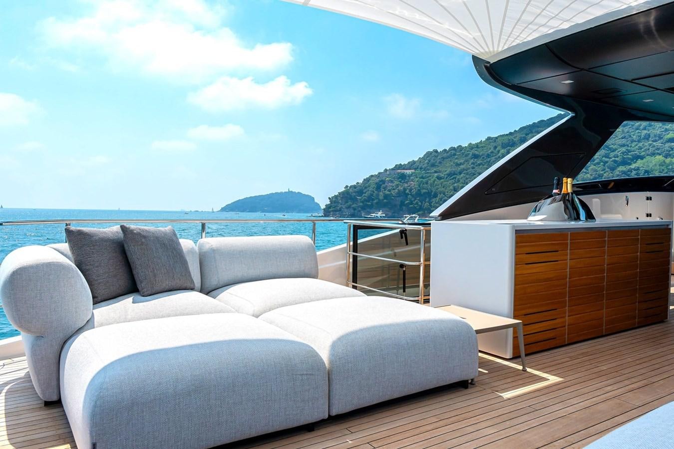 a large white sofa in a room with a view of the ocean aboard #813 - SANLORENZO SL90A Yacht for Sale